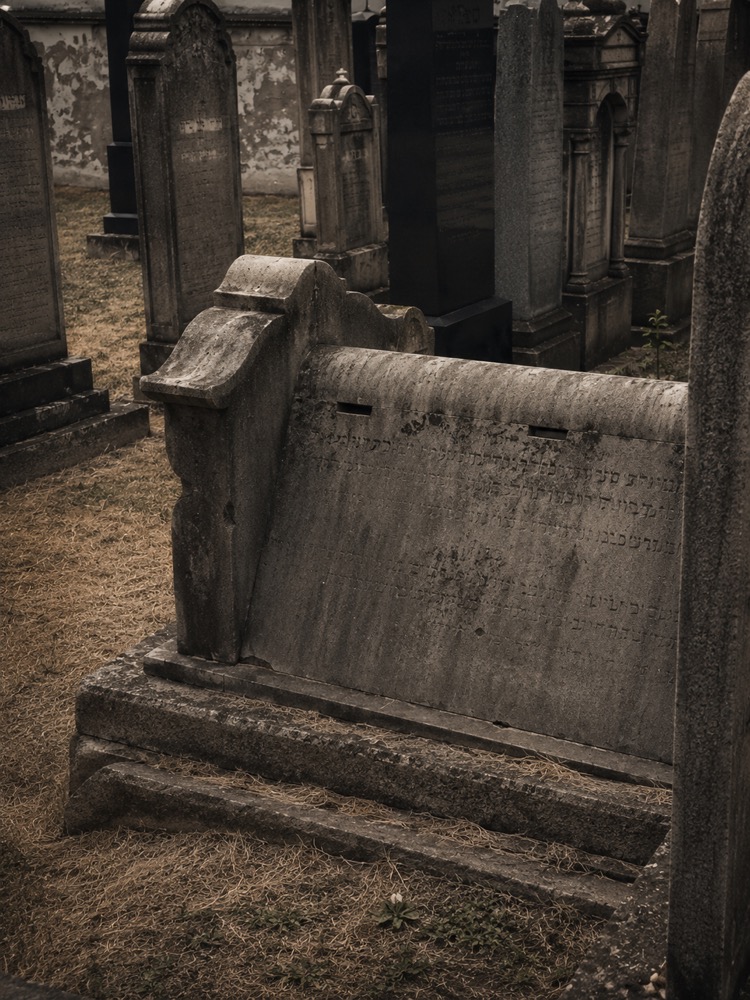 Ohel (funerary structure) with slots for kvitlakh (written prayer requests) at the grave of Yaakov Koppel Reich