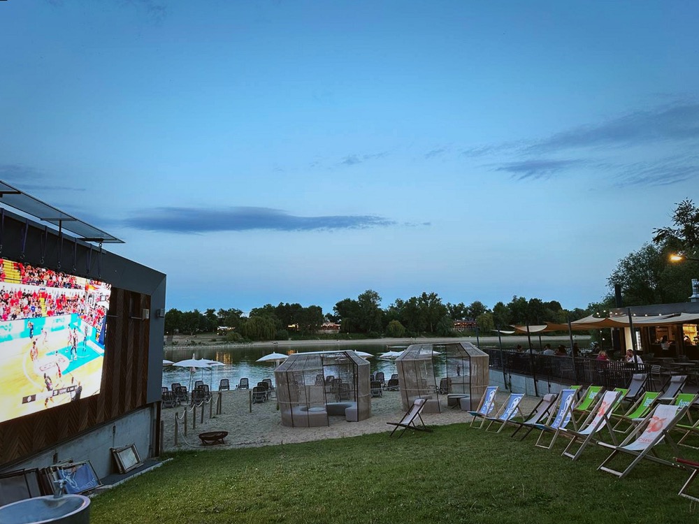 Outdoor screen and deckchairs at dusk